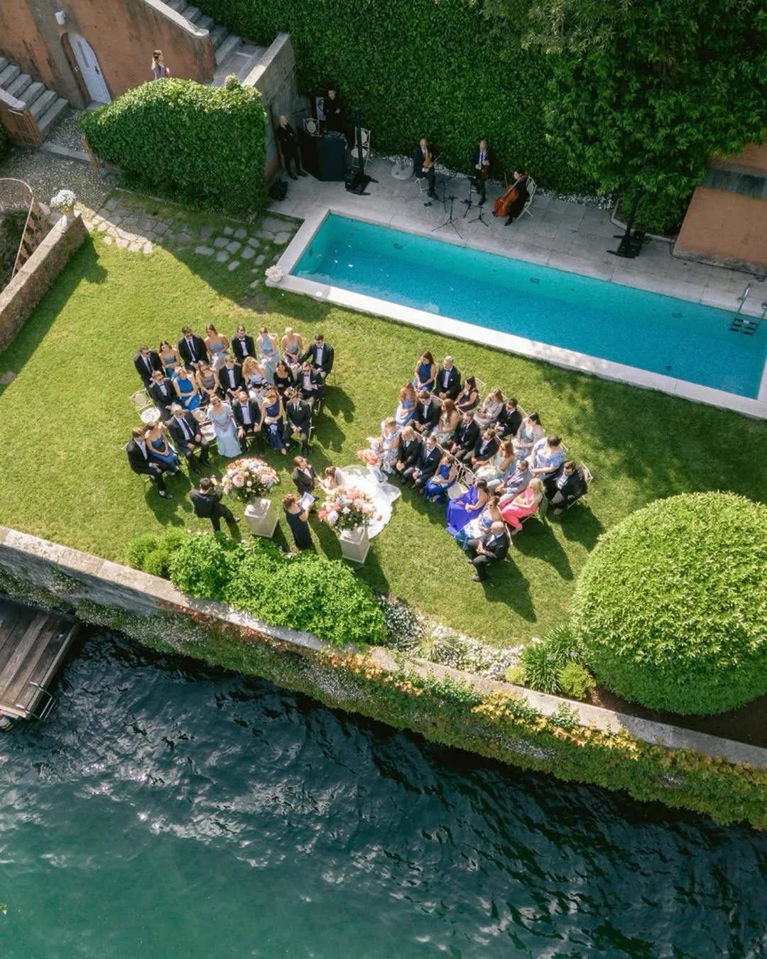 Aerial destination wedding ceremony beside the water