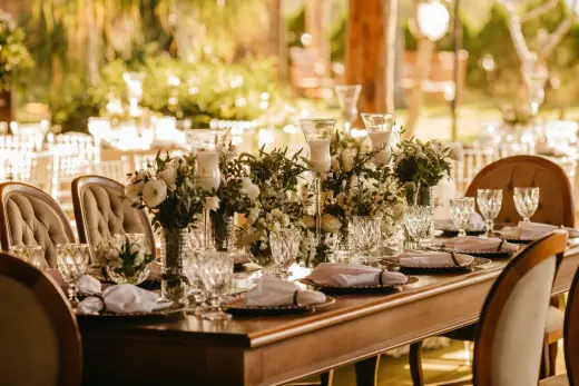 Candlelit outdoor wedding dinner with flowers and place settings