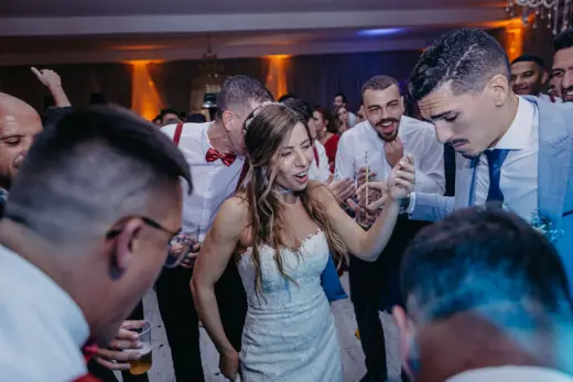 Wedding guests dancing together at the reception
