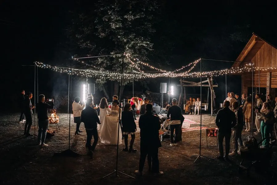 Wedding guests celebrating outdoors at night