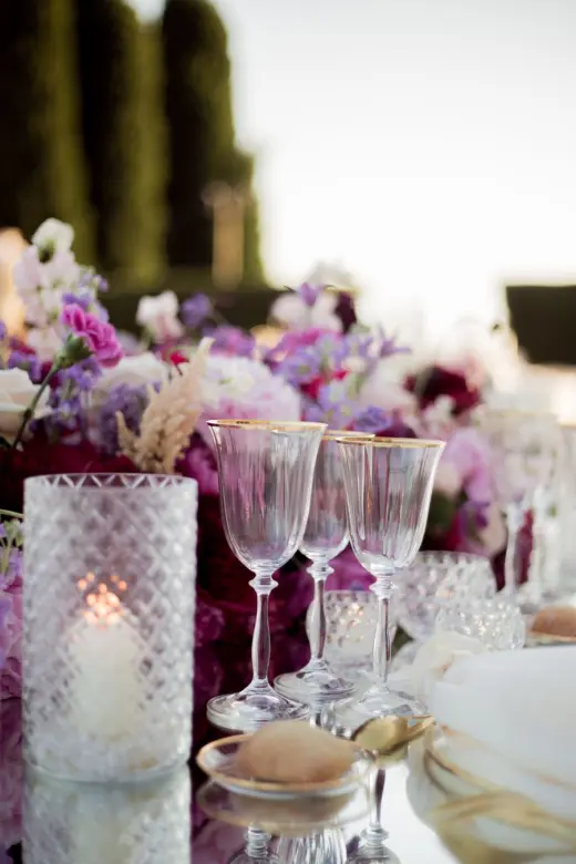 Wine glasses and flowers at an elegant wedding dinner