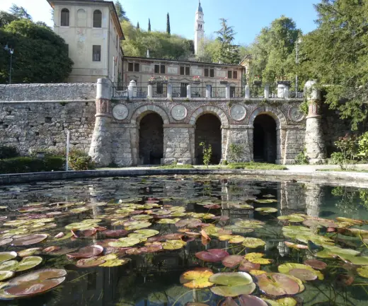 Historic villa courtyard with reflecting pool and arches