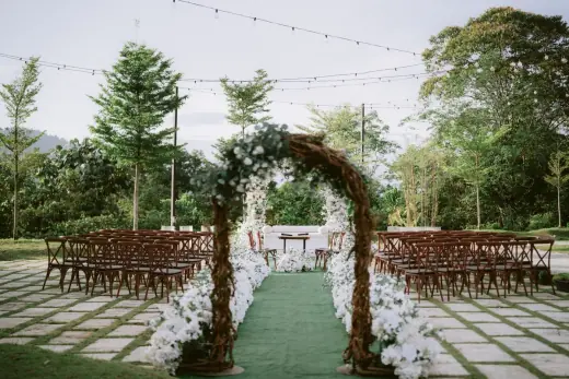 Garden wedding ceremony aisle and arch