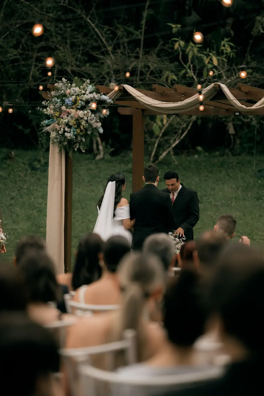 Outdoor ceremony beneath a garden canopy
