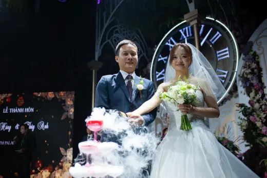 Wedding couple celebrating at a cake table