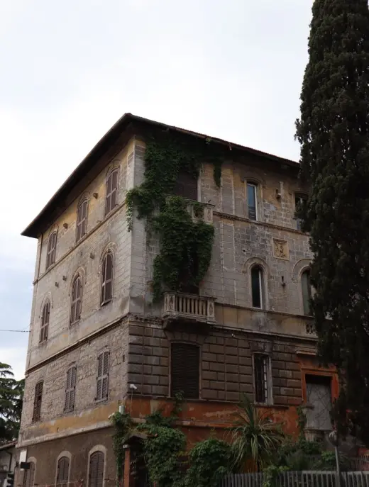 Italian villa building framed by trees