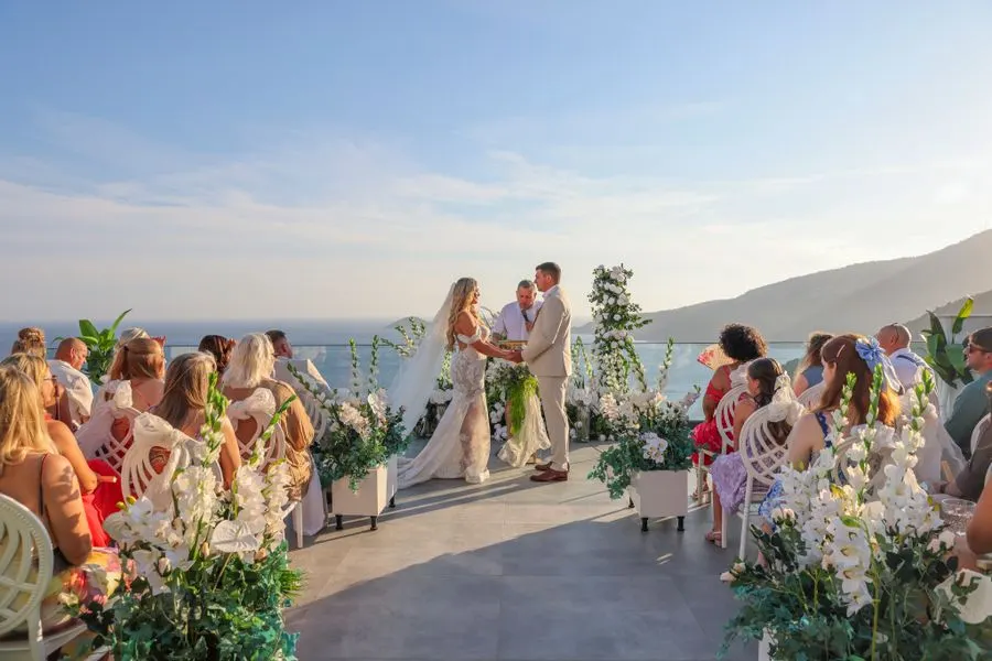 Wedding party celebrating on a coastal terrace